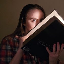 Emily cracks open book